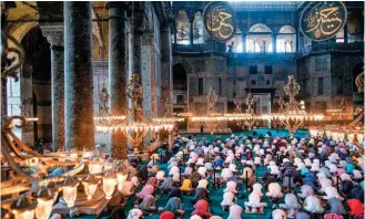  ??  ?? People gathered for noon prayers at Hagia Sophia in Istanbul, on Friday, July 26, two days after it reopened as a mosque.