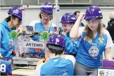  ??  ?? Mentors Adelina Greco and Amy Vickery work in the pit with Build A Dream team members Valerie Alexander, behind, Madison Vickery and Mackenzie Sulyak. The all-girl Build A Dream team won the Rookie Inspiratio­n Award.