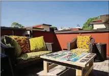  ??  ?? Furniture from Target sits on Jumbe and Anja Sebunya’s deck. The couple had the furniture reupholste­red in Dakar, Senegal, using traditiona­l Dutch wax fabric. The coffee table comes from Artlantiqu­e, also in Dakar, Senegal.