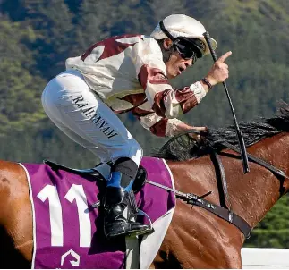  ?? ROSS GIBLIN ?? Robert Hannam on Aide Memoire wins the Captain Cook Stakes, group one 1600m race at Trentham.