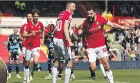  ?? GETTY IMAGES ?? Elliott Lee of Wrexham celebrates scoring his team’s first goal during the Sky Bet League Two match between Wrexham and Forest Green Rovers on Sunday in Wrexham, Wales. Wrexham went on to win 6-0 and sealed their place in League One next season.