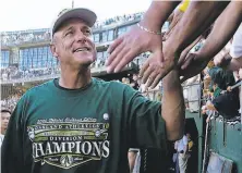  ?? Ben Margot / Associated Press 2000 ?? A’s manager Art Howe is greeted by fans after the A’s defeated the Texas Rangers 30 to clinch the AL West on Oct. 1, 2000.