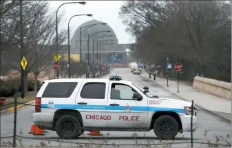  ?? CHARLES REX ARBOGAST — THE ASSOCIATED PRESS ?? A Chicago police officer blocks the road to the Adler Planetariu­m along Lake Michigan on Thursday.