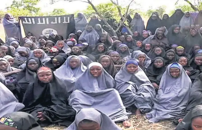  ??  ?? Boko Haram released a video of the girls shortly after it kidnapped them from their school. A year on, most of them are still missing and 17 of their parents have died while awaiting their return