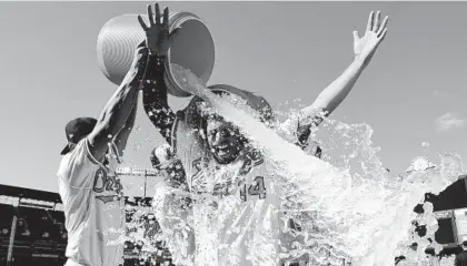  ?? WILL NEWTON/GETTY ?? Rio Ruiz is doused in water after hitting a walk-off home run for the Orioles on Sunday.