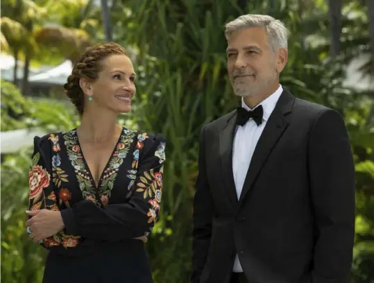  ?? Vince Valitutti/Universal Pictures ?? Julia Roberts and George Clooney portray divorced parents trying to head off their daughter’s wedding in Bali in “Ticket to Paradise.”