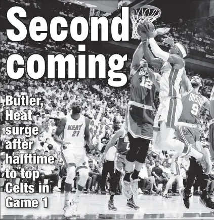  ?? Getty Images ?? BUTLER DOES IT: Jimmy Butler drives to the hoop on his way to a game-high 41 points, including 27 after halftime as the Heat took it to the Celtics in Game 1.