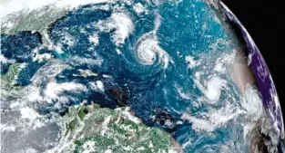  ?? NOAA VIA AP ?? A satellite image shows Tropical Storm Florence, center of photo, in the Atlantic Ocean on Saturday.