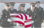  ?? AP PHOTO/MATT HERP ?? Utah National Guard Honor Guard members carry a casket containing the remains of Maj. Brent R. Taylor at the National Guard base on Wednesday in Salt Lake City. The remains of the Utah mayor killed while serving in the National Guard in Afghanista­n were returned to his home state as hundreds of soldiers saluted.