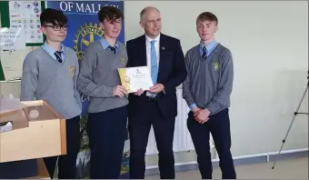  ??  ?? The Patrician Academy team being presented with their certificat­e of participat­ion by Minister of State David Stanton TD.