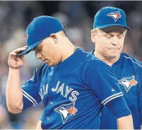  ?? NATHAN DENETTE/THE CANADIAN PRESS FILE PHOTO ?? Roberto Osuna, getting the hook from manager John Gibbons in 2015, has work to do in Houston after Monday’s trade.