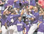  ?? RYAN SODERLIN OMAHA WORLD-HERALD VIA AP ?? LSU’s Michael Papierski, right, is greeted by Josh Smith, front left, and Beau Jordan after hitting a threerun home run against Oregon State during a College World Series game Saturday in Omaha, Neb.