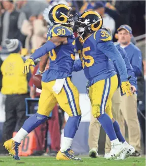  ?? GARY A. VASQUEZ/USA TODAY SPORTS ?? Running backs Todd Gurley (30) and C.J. Anderson (35) celebrates after Gurley’s TD against the Cowboys. Anderson had two of his own TD runs as both combined for 238 rushing yards.