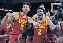  ?? Gina Ferazzi Los Angeles Times ?? USC senior guard Jonah Mathews (2) was celebrated after his last-second three-pointer stunned UCLA 54-52 on March 7.