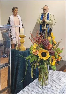  ?? Courtesy Photo ?? The Rev. Elise Cowan (left) and Larry Owensby, president of the board of Unity Church of the Ozarks, pause during the first service at the church’s new location in Bentonvill­e. An open house Nov. 20 will celebrate “a whole new chapter in our ministry. We wish to reach out to the community and seek new ways to serve others.”