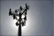  ?? JEFF ROBERSON — THE ASSOCIATED PRESS FILE ?? In this file photo, Nick Blase with True North Management Services climbs down from a cellular phone town after performing maintenanc­e in High Ridge, Mo. Even as the major cellphone companies temporaril­y upgrade service, there are no guarantees cell...