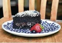 ?? Alison Cook / Staff ?? Dark chocolate cake with coconut and glossy, supple buttercrea­m from Good Vibes Burgers & Brews in Pearland.