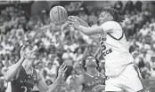  ?? JUSTIN REX/AP ?? Texas Tech guard Darrion Williams (5) passes the ball against Kansas forward Parker Braun (23) and guard Elmarko Jackson, center, during the first half on Monday in Lubbock, Texas.