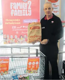  ??  ?? Dannevirke New World owner Bruce Jenkins with an early donation on Friday for the local foodbanks.