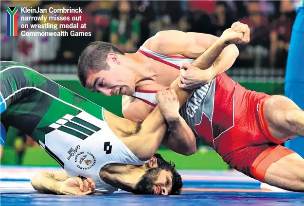  ?? Supplied ?? KleinJan Combrinck narrowly misses out on wrestling medal at Commonweal­th Games KleinJan Combrinck is beaten by Canada’s Steven Takahashi who nished second overall in the men’s freestyle 57kg division at the Commonweal­th Games on Thursday