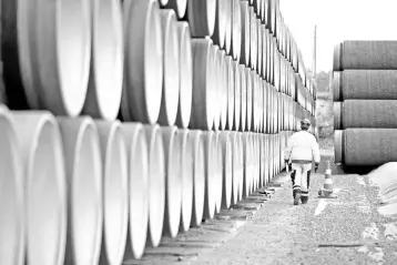  ??  ?? A man walks by a stack of North Stream 2 pipes in Kotka, Finland. Many analysts say the business case for Nord Stream 2 is thin. Another pipeline already links Russia and Germany under the Baltic. – Reuters photo