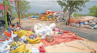  ?? — AFP photos ?? ISLAMABAD: In this picture municipal workers sort out recycling items in Islamabad.