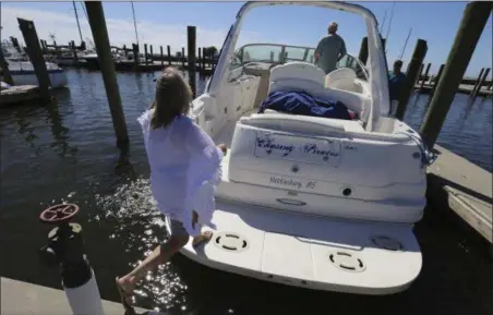  ?? JOHN FITZHUGH — THE SUN HERALD VIA AP ?? Brenda Kent jumps on her boat as she and her husband leave the Biloxi Small Craft Harbor in Biloxi, Miss., on Friday to take the boat up river in advance of Tropical Storm Nate. Gulf Coast residents were bracing Friday for a fast-moving blast of wind,...