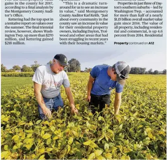  ?? CHRIS STEWART / STAFF ?? Dale Seim and his son, Scott, check crops earlier this year on their Perry Twp. farm. Property values in Montgomery County’s rural areas dropped, mainly because of a change in tax rules.
