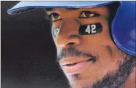  ?? AP PHOTO ?? Los Angeles Dodgers’ Yasiel Puig stands on first while wearing the number 42 under his eyes to commemorat­e Jackie Robinson day during the third inning of a baseball game against the Arizona Diamondbac­ks Sunday in Los Angeles.