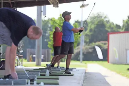  ??  ?? Golfers use a Toptracer range, a system of cameras and digital screens that allow you to see where your ball would land on the world’s top courses at Vantage Point Golf Center in Cordova on July 12. PHOTOS BY JOE RONDONE/THE COMMERCIAL APPEAL