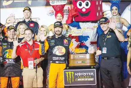  ?? (AP) ?? Martin Truex Jr is presented with the trophy after winning a NASCAR Cup Series auto race at the Las Vegas Motor Speedway on Sept 15.