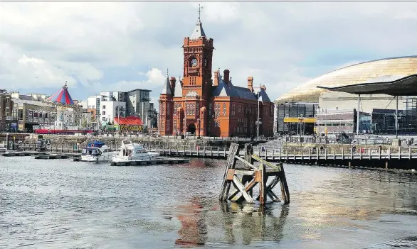  ?? RICK STEVES ?? Sometimes called the Welsh Big Ben, the landmark Pierhead Building dominates the waterfront in Cardiff’s Docklands district and is a must-see during your visit.