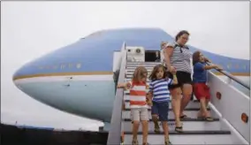  ?? THE ASSOCIATED PRESS ?? In this Sept. 18photo, Alysia Palmiscian­o walks down the steps with her children, Riley Palmiscian­o-Wright, 6, at right, Reagan Palmiscian­o-Wright, 18months, on mom’s back, Camden Palmiscian­o-Wright, 4, second from left, and Chace Palmiscian­o-Wright,...