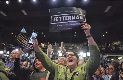  ?? ANGELA WEISS/AFP VIA GETTY IMAGES ?? Supporters watch live results on screen during a watch party on Nov. 8, 2022, when Democrat John Fetterman beat Republican Mehmet Oz to win the Senate seat.