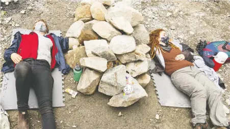  ?? NORMAN GALIMSKI ?? Two protesters lock themselves under a pile of rocks to block the path of loggers in protest of logging old-growth forest near Port Renfrew on Tuesday. At least 137 opponents of old-growth logging have been arrested at the Fairy Creek watershed since May 17.