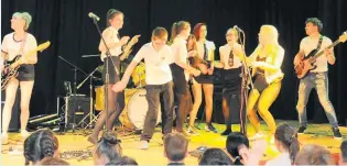  ??  ?? In the limelight Pupils were invited on stage to join 100 Fables during their final song