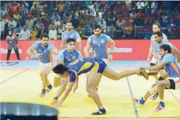  ?? — AFP ?? Thailand’s player vie with India’s player during the semi-final match between India and Thailand of the 2016 Kabaddi World Cup at the Transstadi­a in Ahmedabad on Friday.