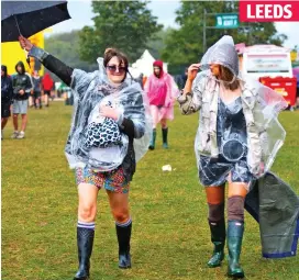  ??  ?? Wet, wet, wet: Revellers at the Leeds Festival yesterday
