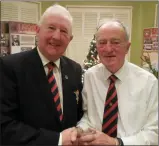  ??  ?? Michael Plunkett is presented with his prize for his recent hole-in-one on the par 3 5th hole at County Louth by Club Captain Harry Collier.