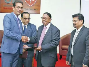  ?? ?? V. Kanagasaba­pathy presents the prospectus to Heshana Kuruppu in the presence of Prof. Chandana Udawatte and CA Sri Lanka Acting Chief Executive Officer Prasanna Liyanage