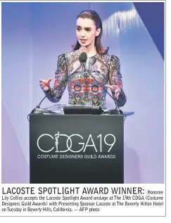  ??  ?? Honoree Lily Collins accepts the Lacoste Spotlight Award onstage at The 19th CDGA (Costume Designers Guild Awards) with Presenting Sponsor Lacoste at The Beverly Hilton Hotel on Tuesday in Beverly Hills, California. — AFP photo