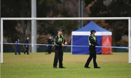  ?? Photograph: James Ross/AAP ?? Police at the football field scene where a woman’s body was found in Carlton North, Melbourne.