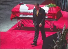  ??  ?? Steven Burns walks past the the casket for his wife, Const. Sara Burns.