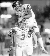  ?? REINHOLD MATAY/STAFF PHOTOGRAPH­ER ?? Dr. Phillips running back Devodney Alford (3) celebrates the winning touchdown with Devon Buckhanon (10).