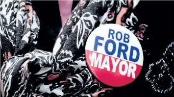  ?? POSTMEDIA NETWORK FILES ?? A women wears a Rob Ford for Mayor button at a special Ford family memorial to honour the late Toronto mayor in 2017.