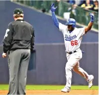  ?? JEFF ROBERSON/ ASSOCIATED PRESS ?? Yasiel Puig of the Los Angeles Dodgers celebrates as he runs the bases after hitting a three-run home run during the sixth inning of Game 7 of the National League Championsh­ip Series against the Brewers on Saturday in Milwaukee.