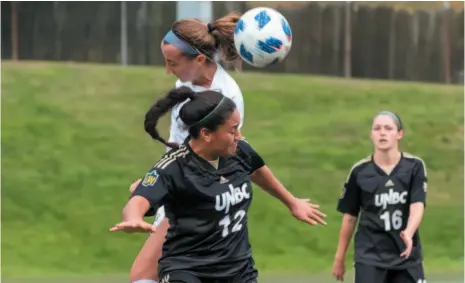  ?? PHOTO COURTESY OF RICH LAM/UBC ATHLETICS ?? Kiana Swift of the UNBC Timberwolv­es wages an aerial battle with a UBC Thunderbir­ds player while UNBC teammate Ashley Volk surveys the scene during a Canada West women’s soccer playoff game at UBC on Sunday.