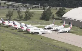  ?? TOM GILBERT Tulsa World via AP ?? American Airlines 737 Max planes being stored at Tulsa Internatio­nal Airport on May 24, 2019. American plans to restart flights on Max planes from Miami Internatio­nal Airport in December.