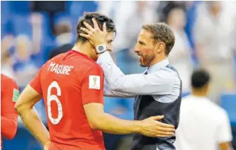  ?? AP PHOTO BY MATTHIAS SCHRADER ?? England head coach Gareth Southgate, right, celebrates Saturday’s victory over Sweden with Harry Maguire during the quarterfin­al match at the 2018 soccer World Cup in the Samara Arena in Samara, Russia.