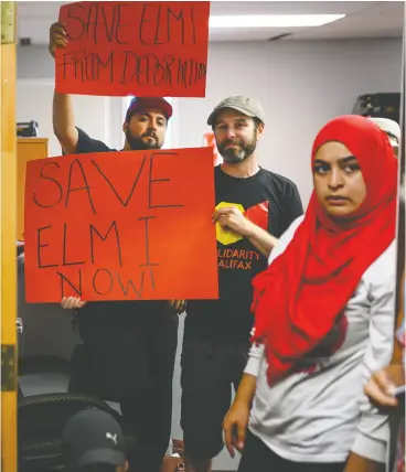  ?? Daren Calabrese / The Canadian Pres ?? Demonstrat­ors stand in the doorway of MP Andy Fillmore’s constituen­cy office in
Halifax on Tuesday advocating for a stay on the deportatio­n of Abdilahi Elmi.